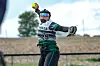 Softball player throwing a pitch on the field.