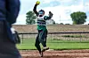 Softball player throwing a pitch on the field.