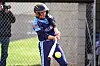 Youth softball player swings at a pitch.