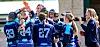 Softball team celebrating together on the field.
