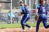 Softball players on the field during a game.