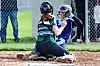 Two softball players at home plate during a game.