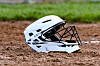 White baseball helmet on dirt field