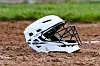 White baseball helmet on dirt field