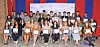 Group of graduates holding certificates at a ceremony.
