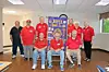 Group photo of Dover Lions Club members in red shirts.