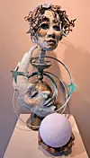 Sculpture with human face and celestial elements.