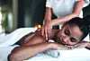 Woman receiving a massage in a spa environment.