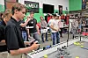 Students controlling robots in a competition environment.