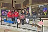 Group of people in red shirts outside an ice cream shop.