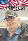 Portrait of a man in a Veteran cap under an American flag graphic with the word VETERAN above him.