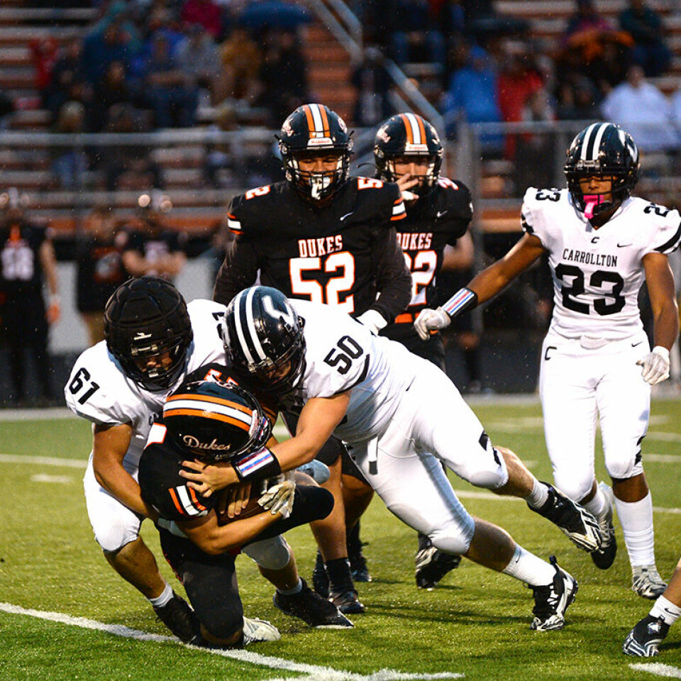 CCM/Carol McIntireCarrollton defenders Josh Rhiel (61) and Dillon Naylor (50) bring down Marlington running back Luke Stanley for a loss during first half action of a game Friday in Alliance.