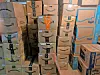 Stacks of Amazon shipping boxes arranged in a storage space.