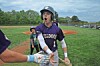 Young baseball player in a Wildcats jersey high-fives a teammate on a baseball field.