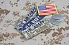 U.S. Army and U.S. Navy name tapes and an American flag patch on camouflage fabric.
