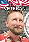 Portrait of a man standing before an American flag design and the word “VETERAN.”