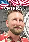Portrait of a man standing before an American flag design and the word “VETERAN.”