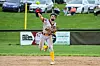 A baseball pitcher in a striped uniform throws a pitch on a dirt mound.
