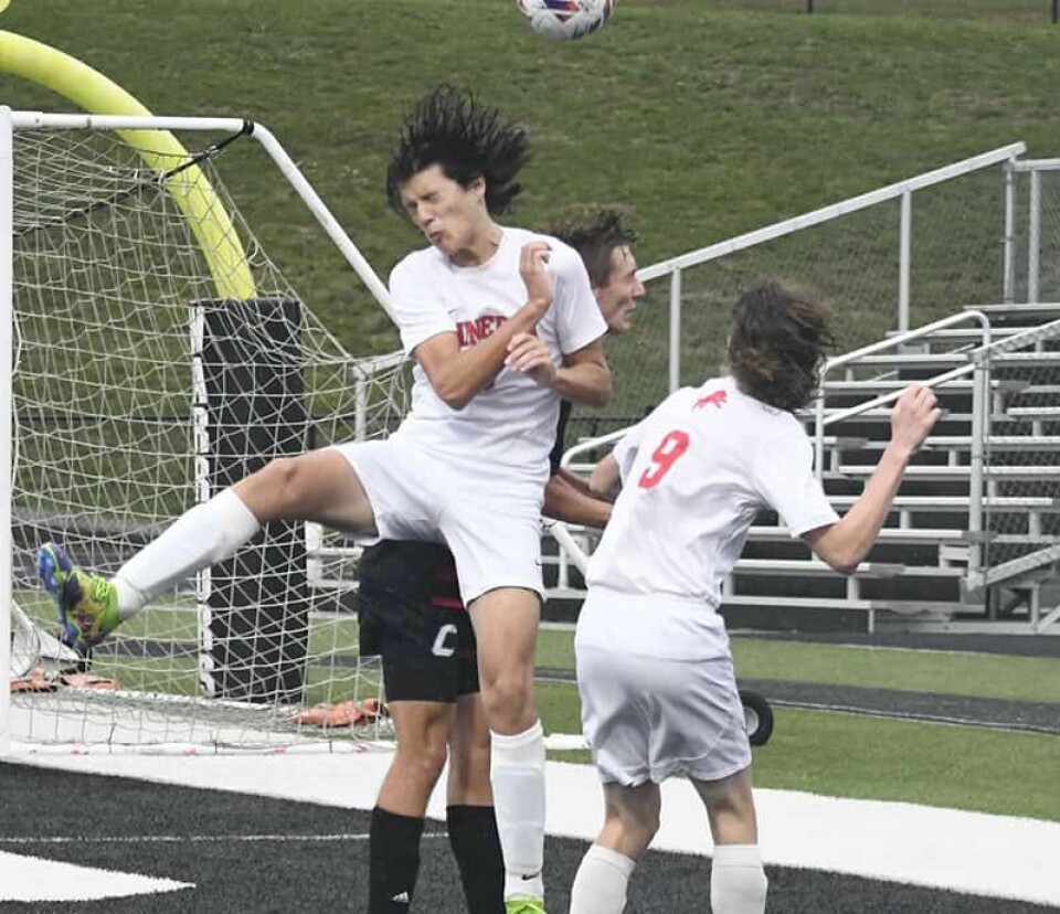 CCM/Carol McIntireMinerva freshman Wyatt Gonzalez heads the ball following a Carrollton corner kick in a game last week at Carrollton.