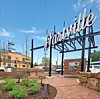 Hartsville sign over a brick plaza with stone landscaping and the Hartsville Elevator building nearby.