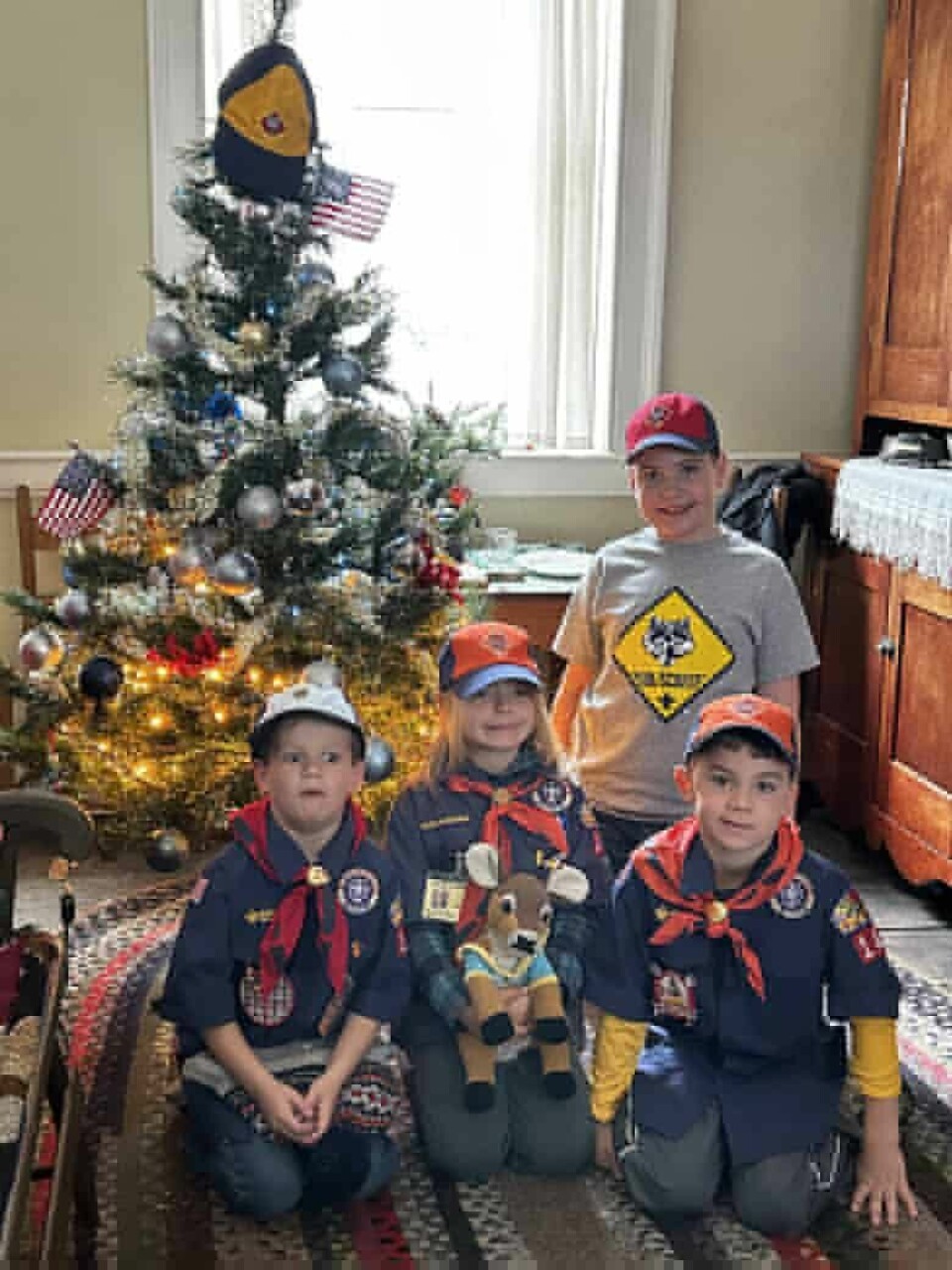 Submitted PhotoCub Scouts Pack 141 members (from left) Oliver Clemens, Julia Gardner, Aedan Wilson and Will Dodds (back) are shown with the tree the group decorated at the McCook House.