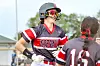 Two softball players in gray and red uniforms stand on a softball field.
