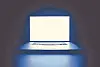 Open laptop with a bright screen glowing in a dark room.
