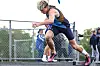 Runner launching from starting blocks on an outdoor track.