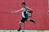 Athlete in a teal jersey throwing a discus on a field.