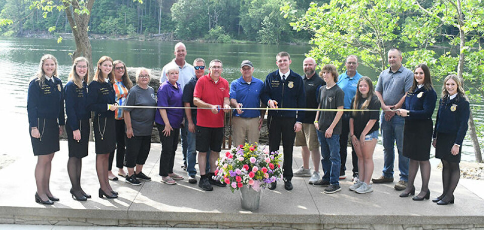CCM/ Carol McIntireThose participating in a ribbon cutting ceremony at Blue Gill Rock at FFA Camp Muskingum are shown above. From left are: Ava Evers, Lauren Thornhill, Kaydence Morris, all Ohio FFA state officers; Allysa Bregal, FFA Camp Board of Trustees chairman; Gerry Marteney, Elaine Painting, Ashton Preservation Association; Matt Mellinger, Easton Construction; Bob Mason, Mason Cement; Todd Davis, FFA Camp director; Jim Sutton, FFA Camp maintenance director; Luke Jennings, state FFA president; Andre Servais, Pro AV of Ohio; Jarrett Stahler, FFA member and camper; Craig Butler, MWCD executive director; Addison Holowitz FFA member and camper; Zeb Casper, Casper Welding; Delaney Moore and Katelyn Kinsella, state FFA officers.