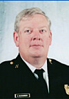 Studio portrait of a uniformed officer facing the camera against a plain background.