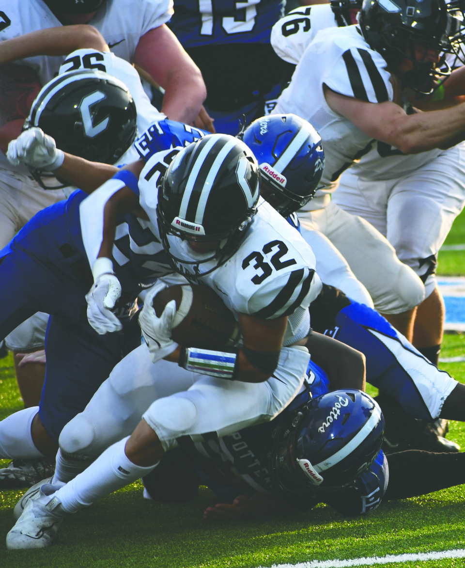 CCM/Dan RiesWarrior running back Levi Kiko (32) is brought down from behind by a Potter defender.