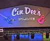Stage sign reading Cin Dee’s Place with blue and pink guitar decorations.