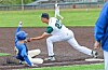 A baseball player in blue slides into second base while a player in white tags him out.
