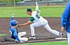 A baseball player in blue slides into second base while a player in white tags him out.