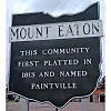 Roadside sign reading Mount Eaton, with text about the community being first platted in 1813 and named Paintville.