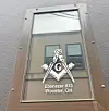 Metal plaque on a building entrance with the Masonic square and compass symbol and Ebenezer #33, Wooster, OH.