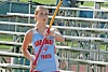 Track athlete in a Garaway Track jersey holding a pole near bleachers.