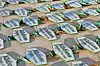 Rows of green-and-white branded cards scattered on a tiled floor.