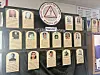 A wall display of framed portrait plaques arranged in rows.