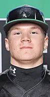 Close-up portrait of a baseball player wearing a black cap and black Under Armour uniform.