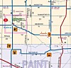 Printed map with roads, district labels, route markers, and a blue route line across the area.