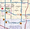 Printed map with roads, district labels, route markers, and a blue route line across the area.