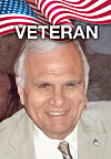 Portrait of a smiling man in a suit under a U.S. flag graphic labeled veteran.