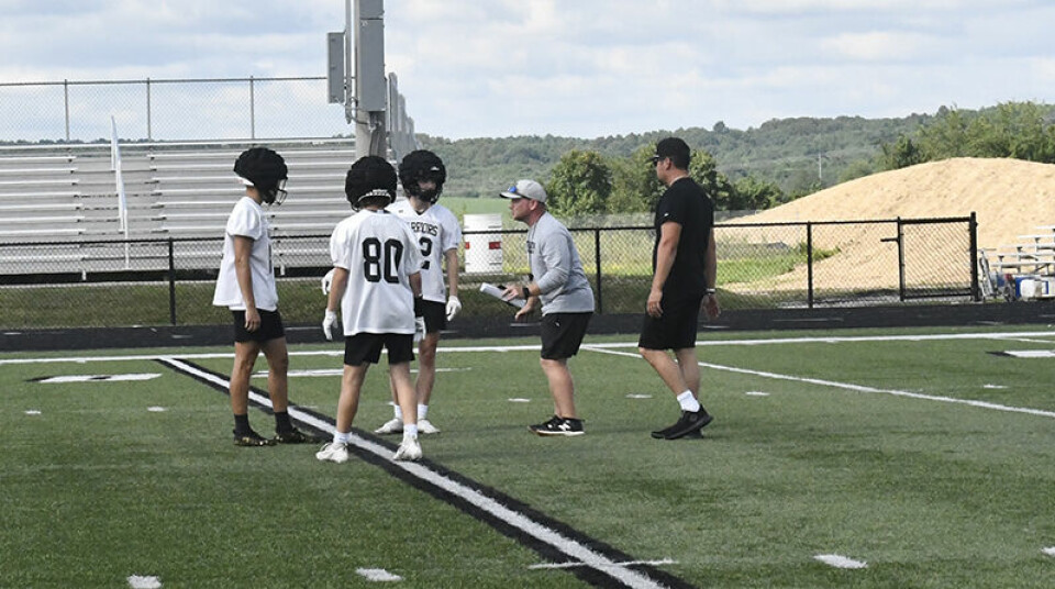 CCM/Carol McIntireStorm Hill, Carrollton’s new football coach, instructs players during a 7-on-7 event held July 11 at Community Field. The Warriors were facing Malvern in the drill.