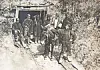 Workers stand with a mule-drawn cart at a tunnel entrance carved into a rocky hillside.