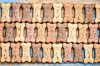Close-up of a decorative wall made of repeating textured stone blocks in beige, tan, and blue.