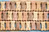 Close-up of a decorative wall made of repeating textured stone blocks in beige, tan, and blue.