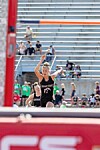 Athlete in black uniform near a high jump bar during a track and field event.