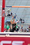 Athlete in black uniform near a high jump bar during a track and field event.